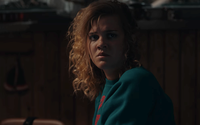 A teen girl at a kitchen table