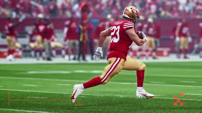 A dynamic action shot of a running back breaking through defenders on the field.