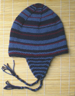 Urban ear-flap hat features random stripes