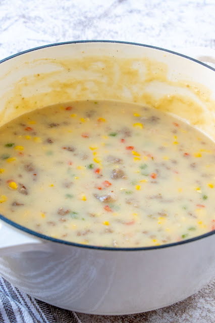 chowder in a white cooking pot.