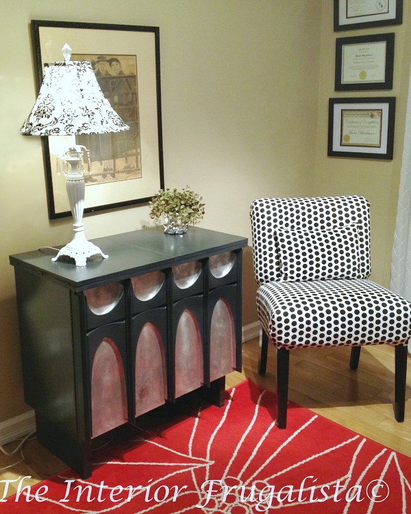 Mid-century modern sewing cabinet makeover after replacing missing trim on cabinet door with baking clay.