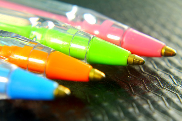 Colorful ballpoint pens green orange blue pink