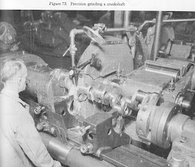 Elderly machinist operating a large metal lathe