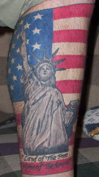 Statue of liberty with flag tattoo.