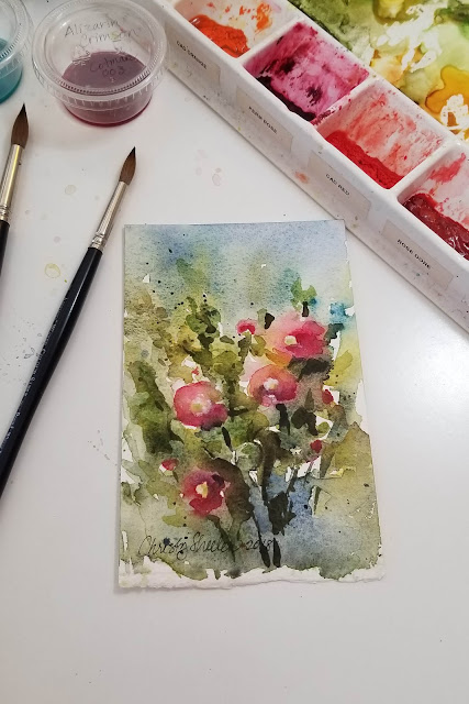 Hollyhocks in watercolor on watercolor paper.  