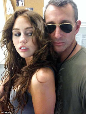 Miley Cyrus strikes a provocative pose with Adam Shankman