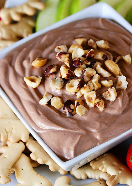 Close-Up of a Bowl of Nutella Greek Yogurt Dip Topped with Chopped Hazelnuts Image