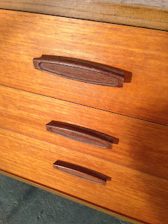 Solid afromosia teak handles on the chest of drawers