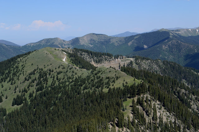 grassy ridge to a road by a building