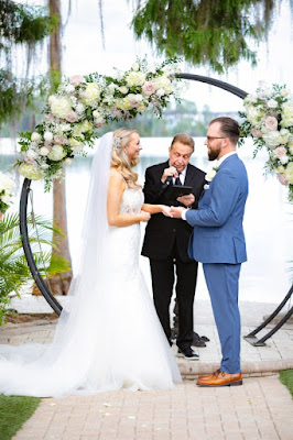 groom and bride holding hands at the ceremony