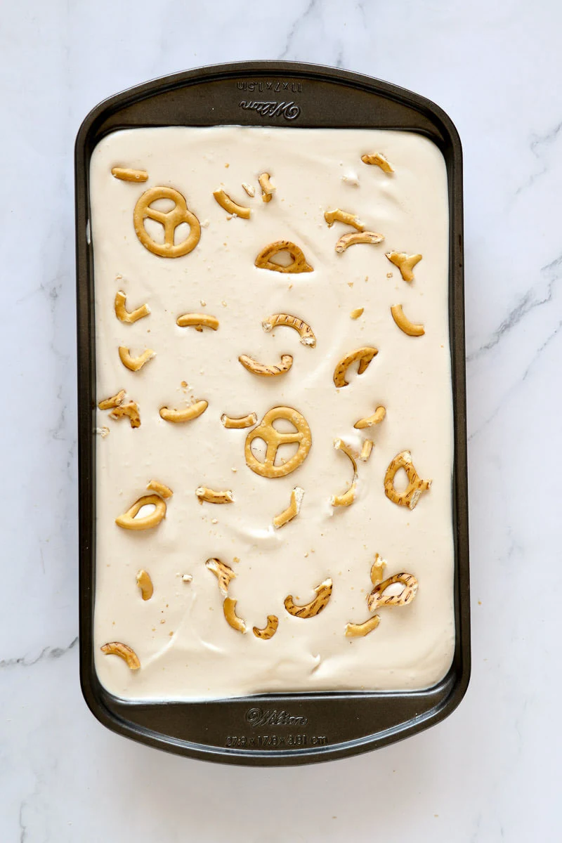 Guinness stout ice cream in a loaf pan with salted pretzels.