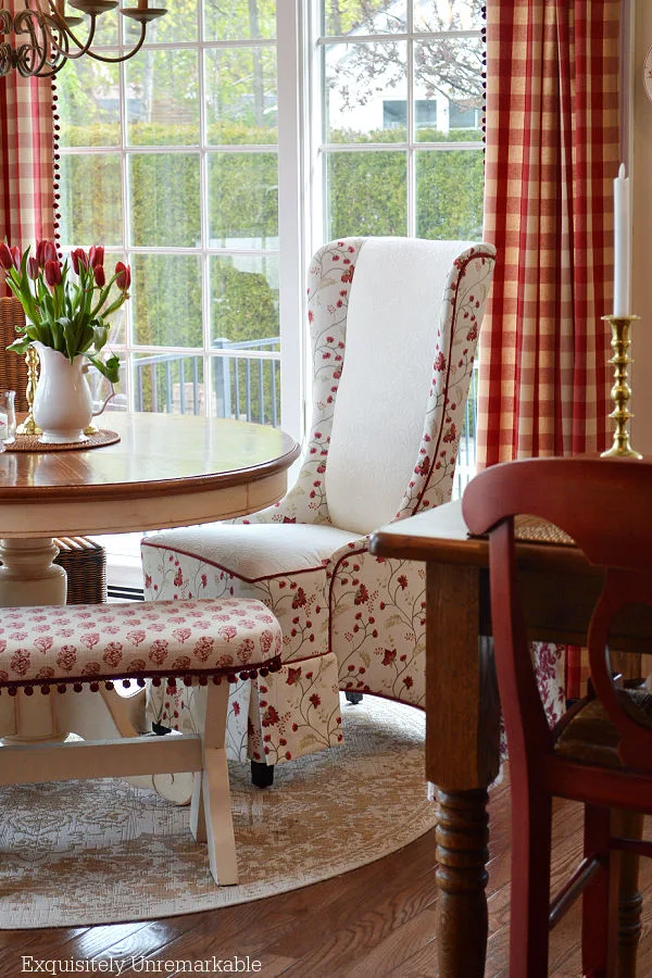 Cottage Style Red and White Dining Area with floral chair and pom pom trim bench