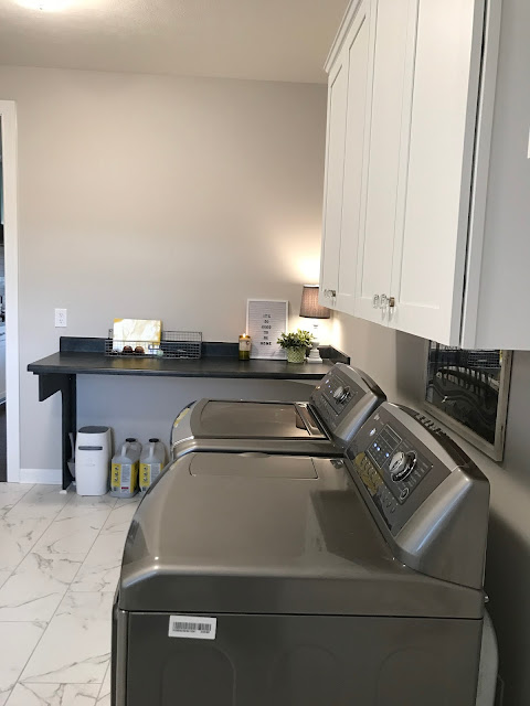 Laundry room with faux marble tile