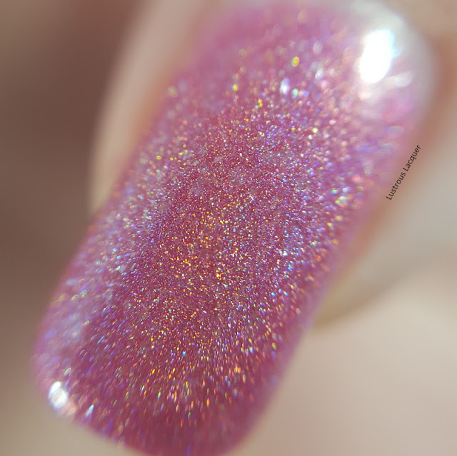 Medium-pink-linear-holographic-nail-polish-with-scattered-holographic-glass-flecks