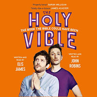 Elis and John Present the Holy Vible audiobook cover. Elis James (left) stands with hands clasped in prayer, wearing a blue shirt. John Robins (right) in purple, looks into the camera. The background is orange with the title above the men.