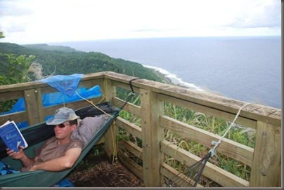 Jason strings up a hammock at the overlook on 'Eua