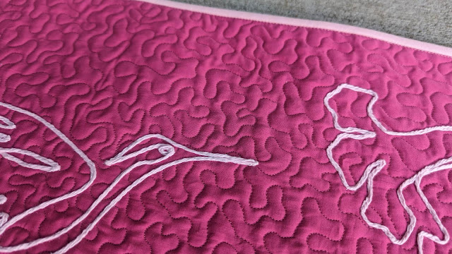 Pink hummingbird mini quilt using yarn couching