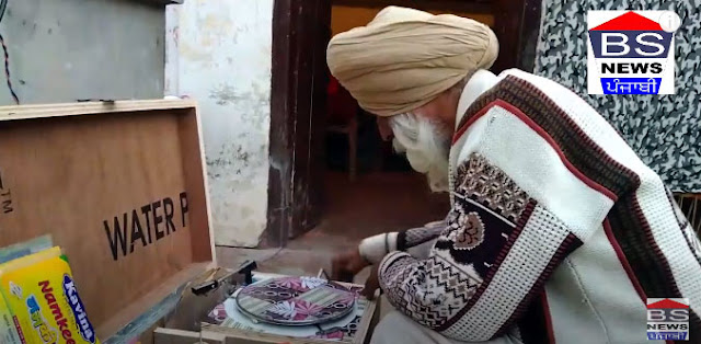 A matter of time - Mandir Singh Sakkanwali sitting holding a fifty-year-old pan and pan machine