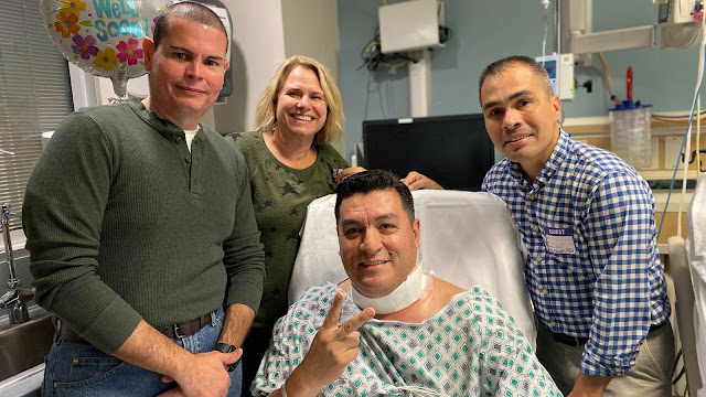 Army veterinarians Lt. Col. Luis Lugo, Lt. Col. Krinon Moccia, and retired Army Master Sgt. Michael Junio, visit Oscar Sanchez in the hospital. The trio saved Sanchez’s life after his throat was slashed in a random attack in Louisville, Ky., on Oct. 24, 2022.  (Photo courtesy of Oscar Sanchez)