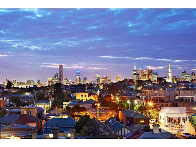 Photo of Melbourne skyline view at sunset as seen from the terrace of modern home