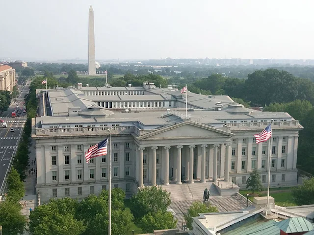 Cover Image Attribute: 2015 file photo of the US Treasury building in Washington, DC. Washington Monument in the background. / Source: MeanieHyaena, Wikimedia Commons