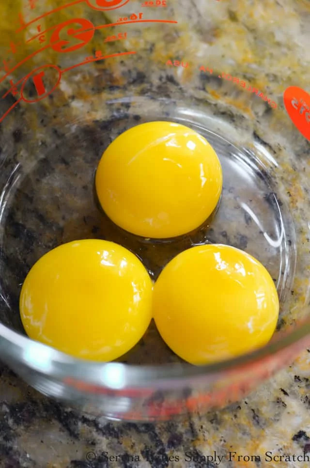 3 Egg Yolks in Glass Mixing Cup.