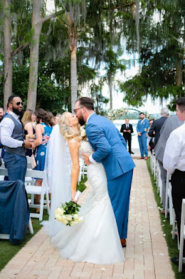 bride and kissing in the missle of ceremony aisle