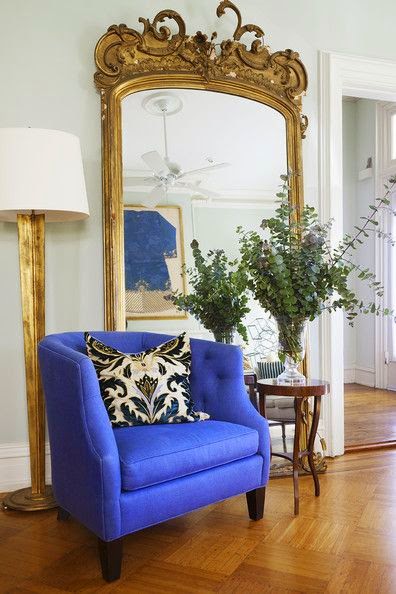 white living room with pop of bright blue color and gold