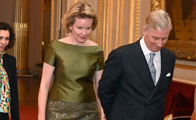 Queen Mathilde wore a green half sleeve silk satin blouse by Natan, and a green embroidered midi skirt by Natan