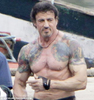 Hey look it's Sylvester Stallone showing us his tattoos For an old man 