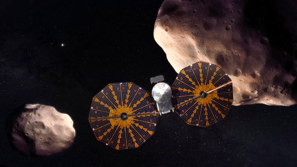 An artist's concept of NASA's Lucy spacecraft venturing past the Trojan asteroid Patroclus and its binary companion Menoetius near Jupiter's orbit.