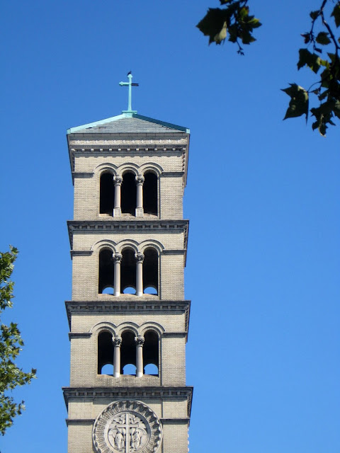 Church tower against the sky with leaves