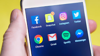 A picture of a phone screen with social media apps in the focus of attention.