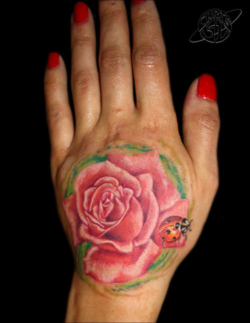 Rose hand tattoo with ladybug