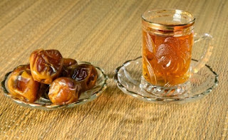 Small teacup and saucer and a small plate of dates