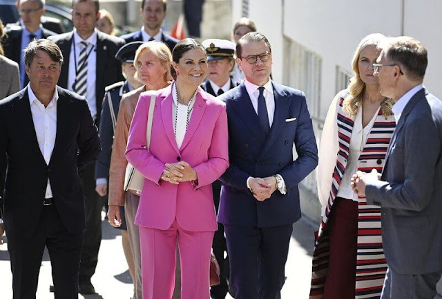 Princess Mette-Marit wore a satin trench coat by Tome, Princess Victoria wore a satin blouse by Peter Pilotto, and pink suit