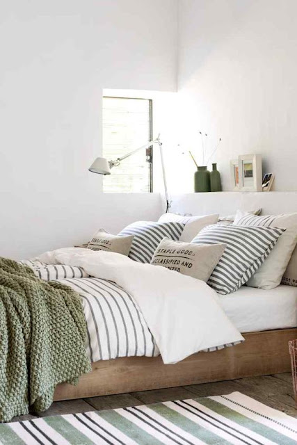 neutral bedroom, striped bedding, green throw 