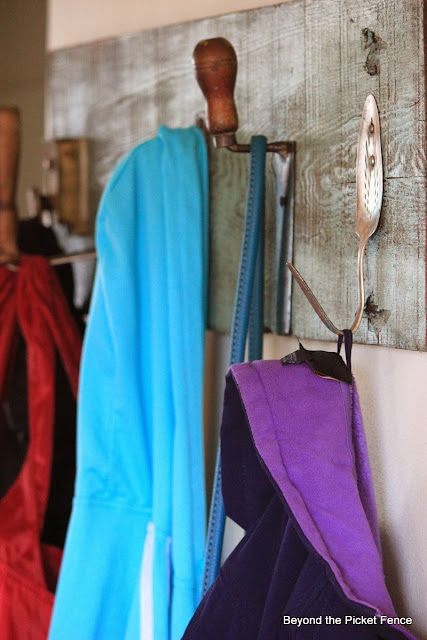 Repurposed Junk Coat Hook using a potato masher, pulley, trowel, door loock and cake server as hooks with reclaimed wood http://bec4-beyondthepicketfence.blogspot.com/2014/01/repurposed-junk-coat-hook.html