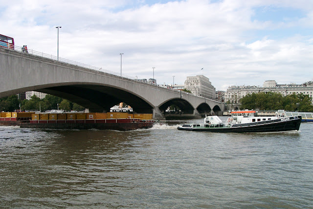 Thames tug Regain towing barges, Waterloo Bridge, River Thames, London