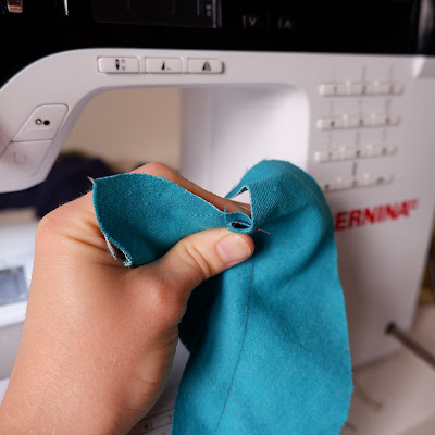 Flat felled jeans seam step 3. The wider raw edge is wrapped round the narrower one.