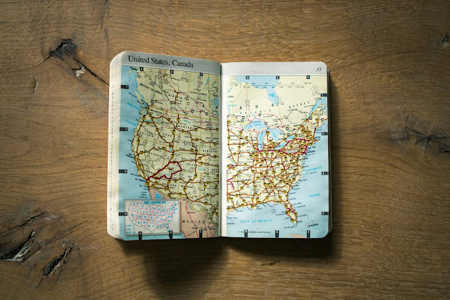 map book on wood:Photo by Domino on Unsplash