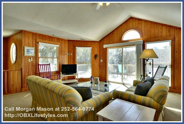 The living area great room of this Outer Banks NC home for sale has cathedral ceilings and an open and airy floor plan. 
