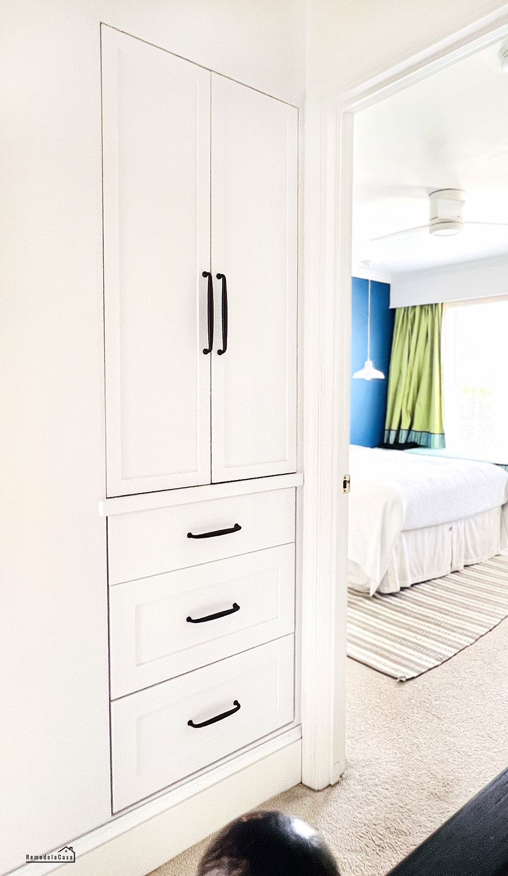 a linen closet is transformed with drawers and shelves behind closed doors