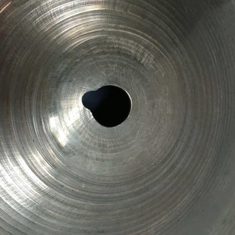 Example of "keyholing" around cymbal mount hole