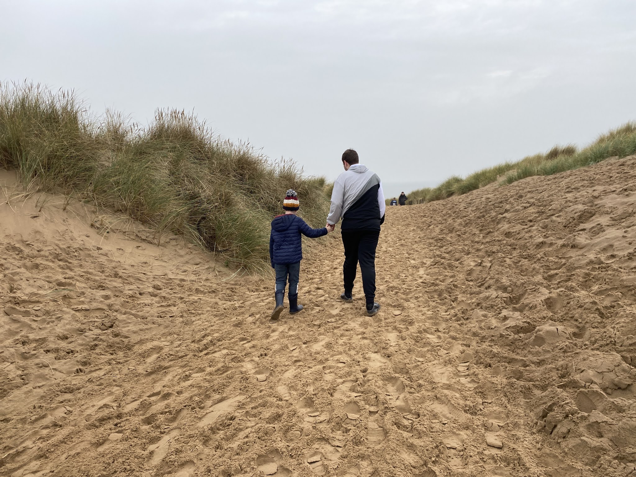 boys walking over Sand Dunes