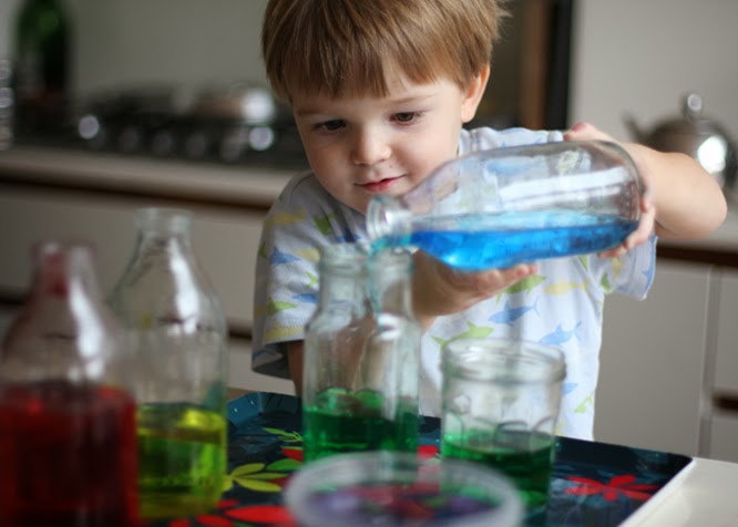 Henry pouring water coloured with food colouring