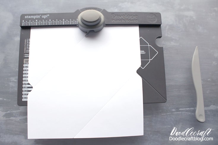 Once lined up, push the button and score the line.  Rotate the paper and repeat the process.
