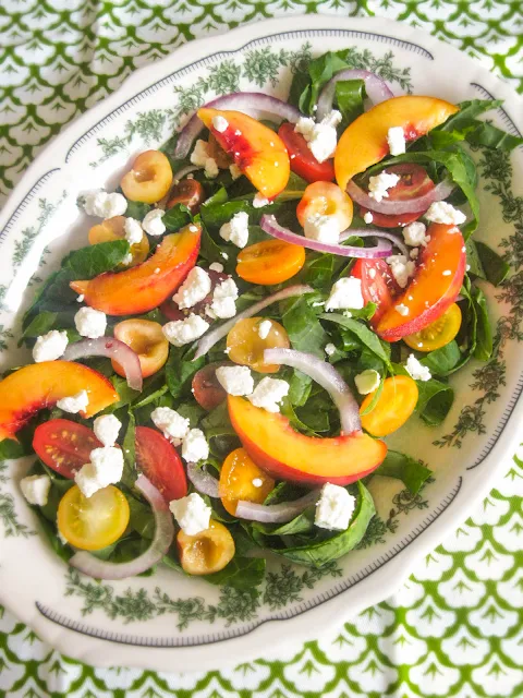 This Peach and Cherry Salad is lite and fresh with red onions and a sprinkle of feta on my favorite bed of leafy greens and tender collard ribbons.