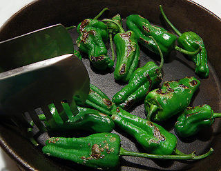 Tongs Moving Peppers Around Frying Pan