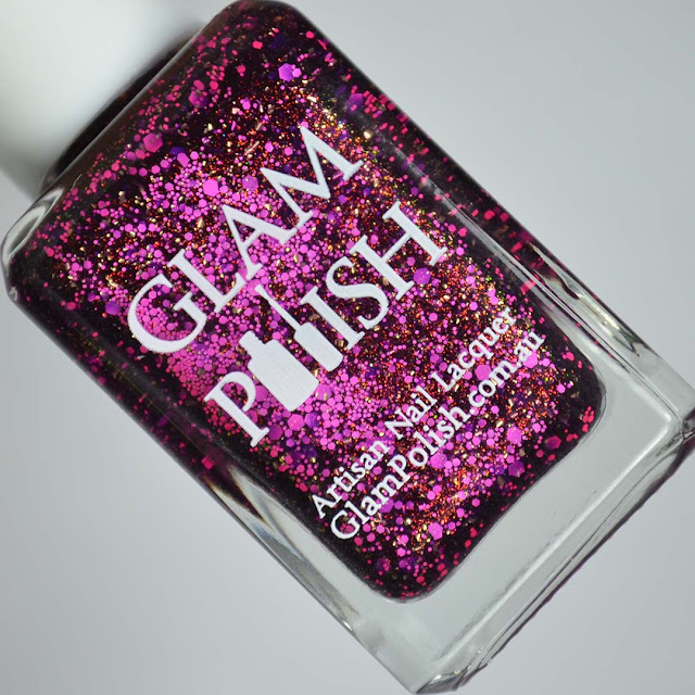 purple nail polish with pink glitter in a bottle